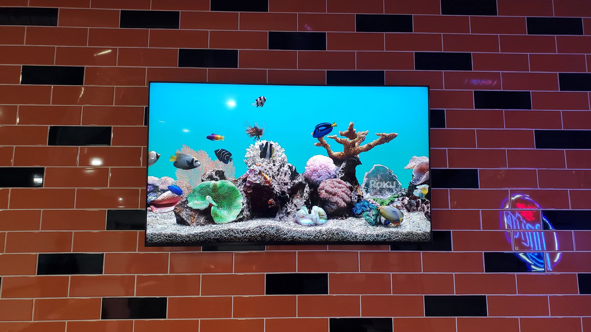 TV screen mounted on a ceramic tile wall custom mounted by fisher custom av.