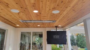 Outdoor patio ceiling with recessed lights, heater, outdoor speakers, and a outdoor TV with a protective cover.