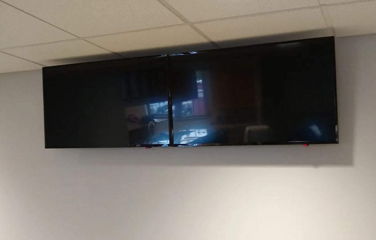 two tvs mounted side by side in local business in norwalk ohio by fisher custom av
