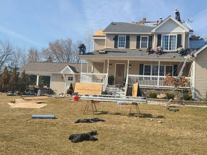 A house is being remodeled with a roof being installed.