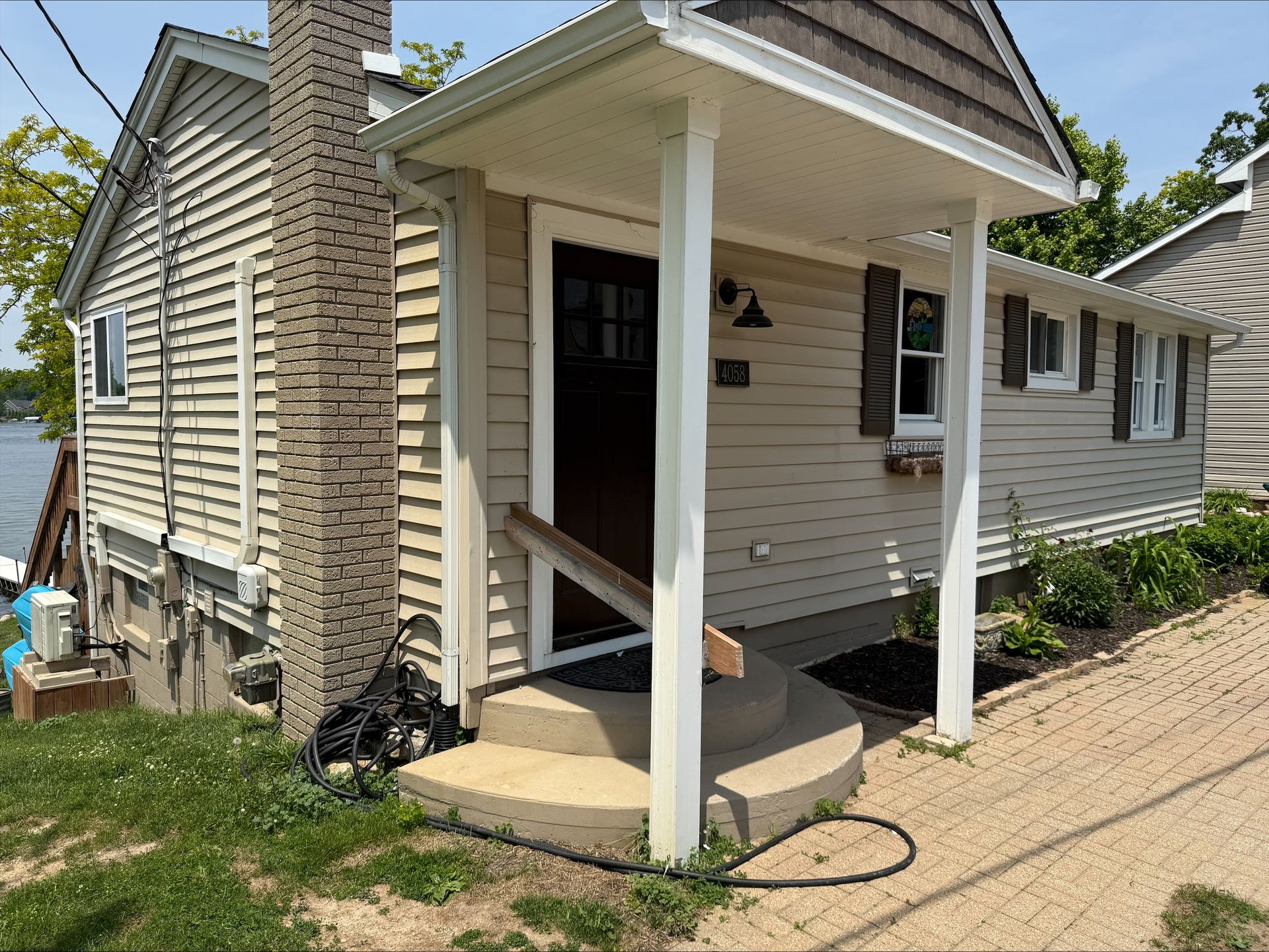 Small Beige House With White Porch
