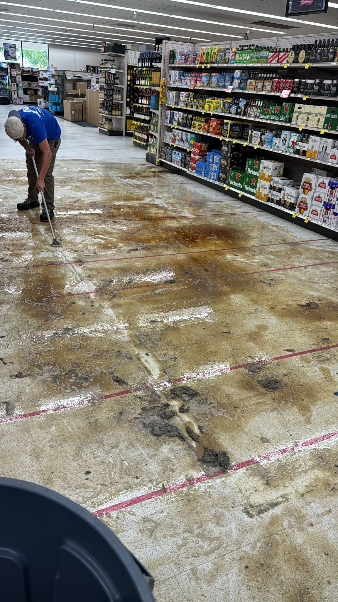 A man is cleaning the floor of a store.