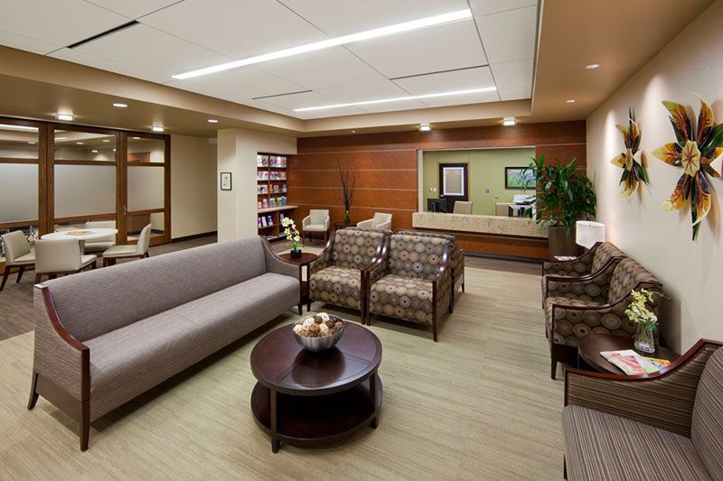 A living room with a couch and chairs and a table