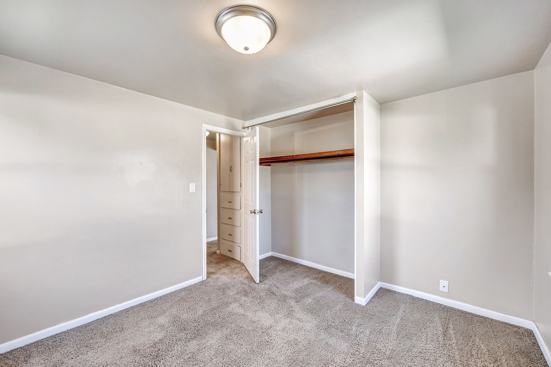 There is a closet in the corner of the room.