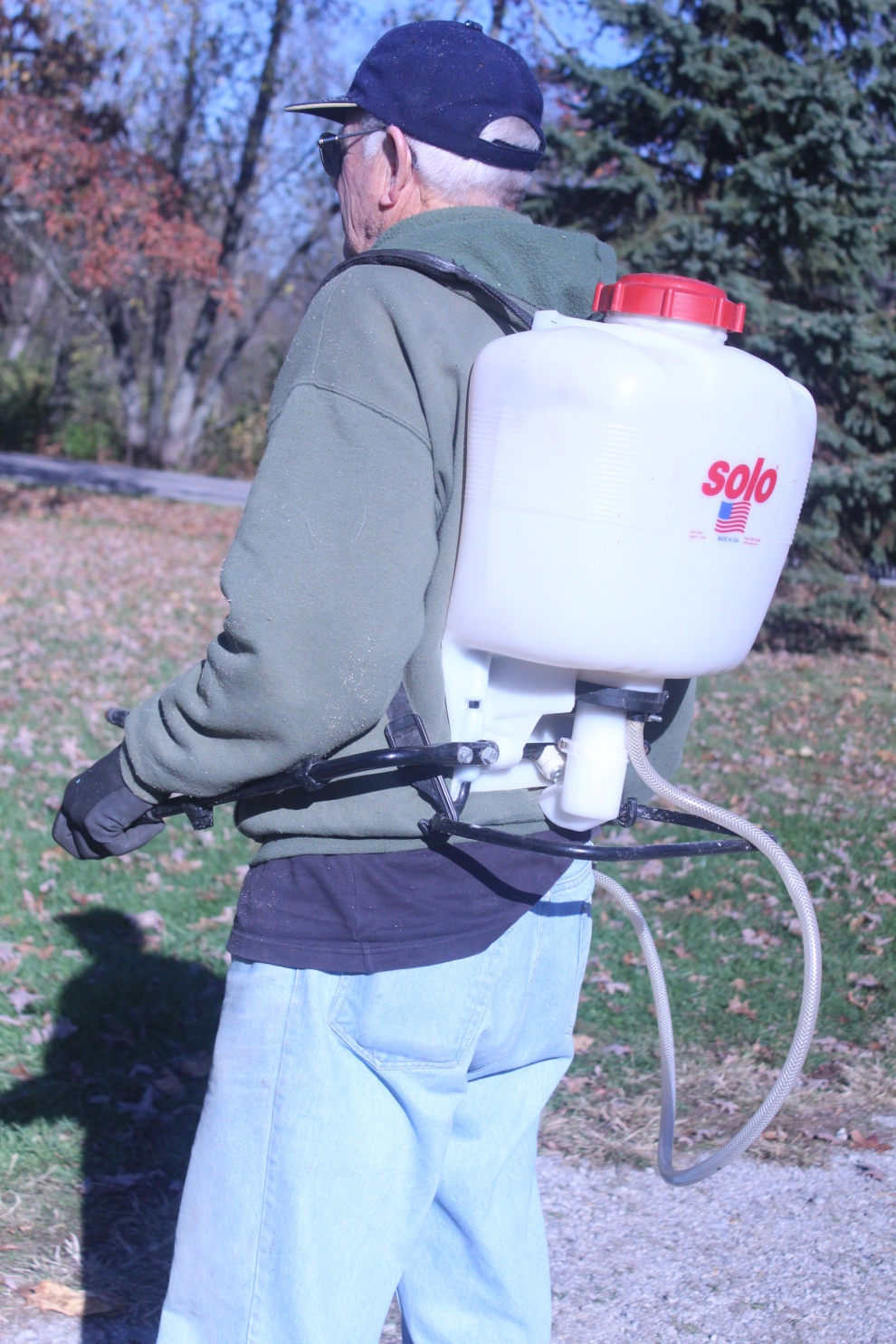 Photo of four gallon back-pack sprayer being used for holistic sprays