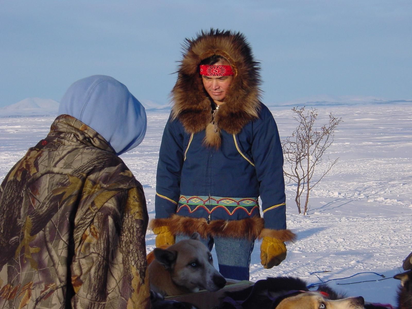 Two Inuit people on frozen tundra