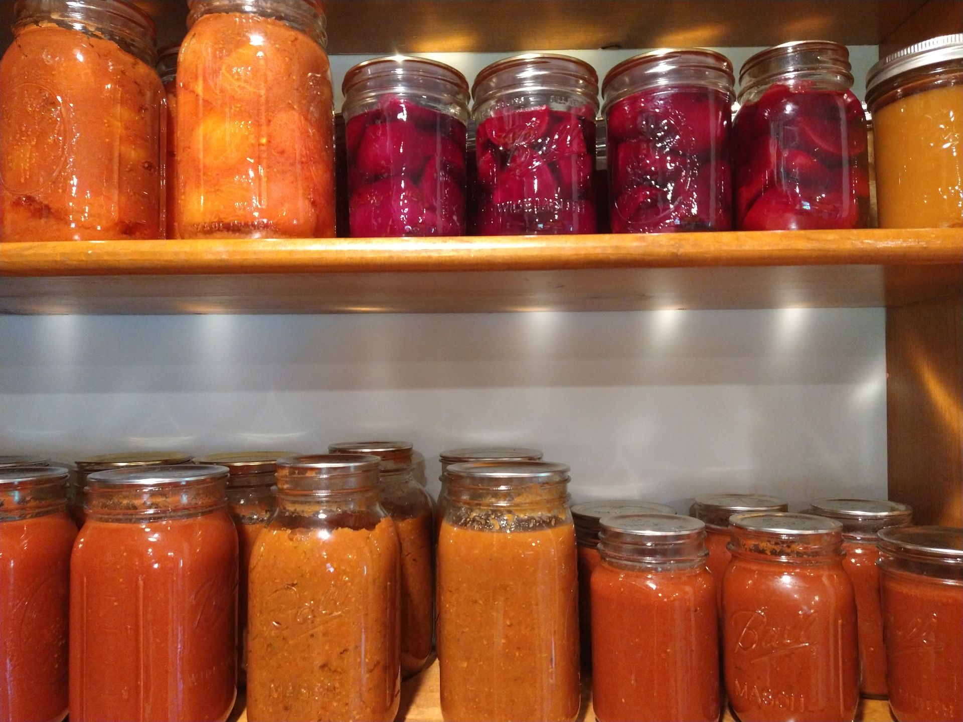 canned produce including whole tomatoes, pickled beets, tomato sauce and