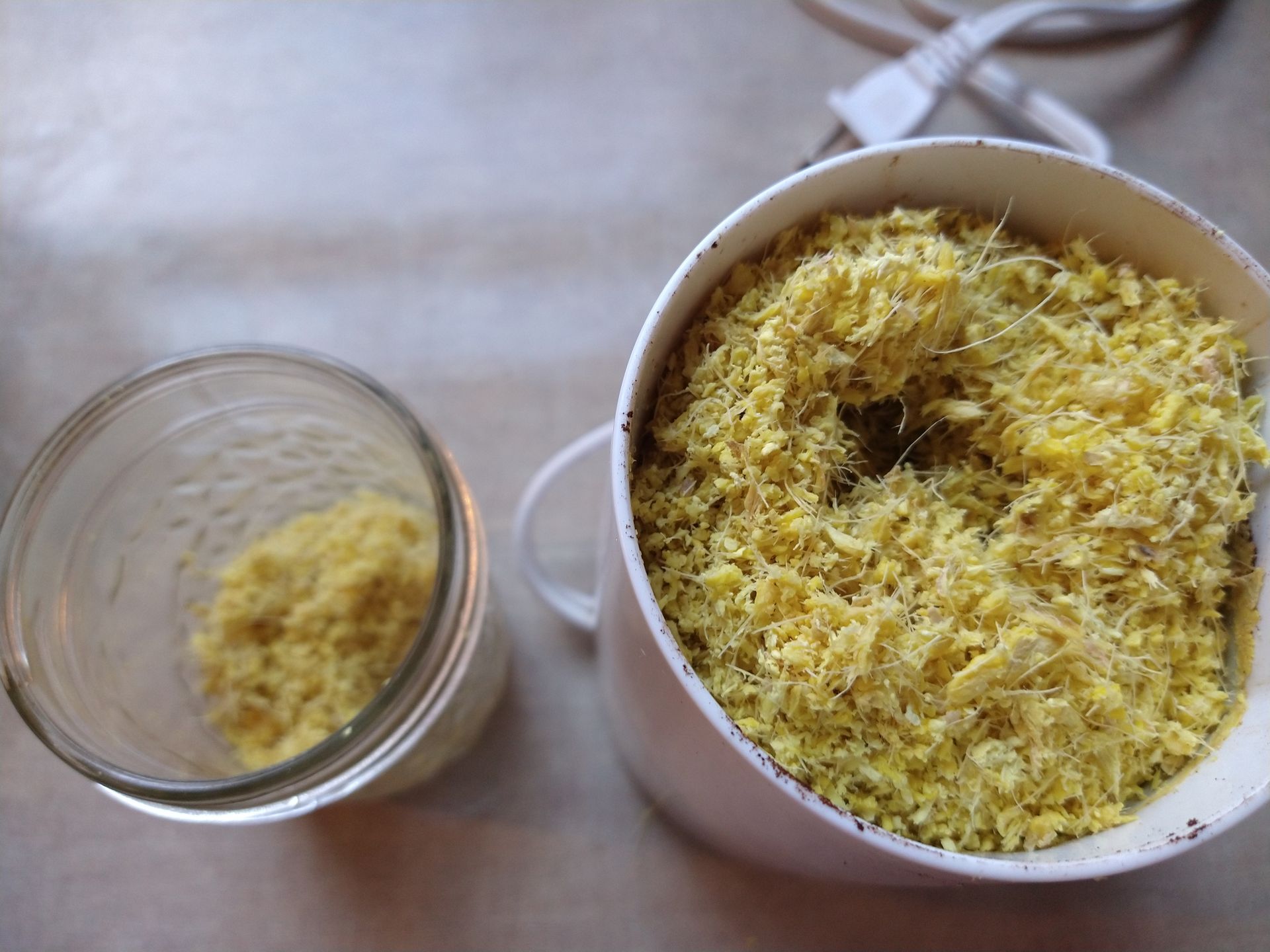 dried ground ginger in coffee grinder and storage jar