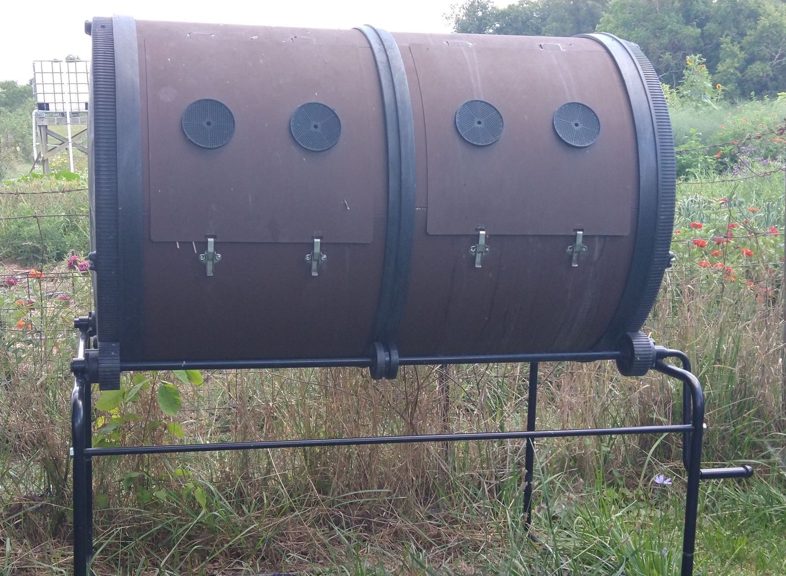 Large compost tumbler with two sides and a handle for turning