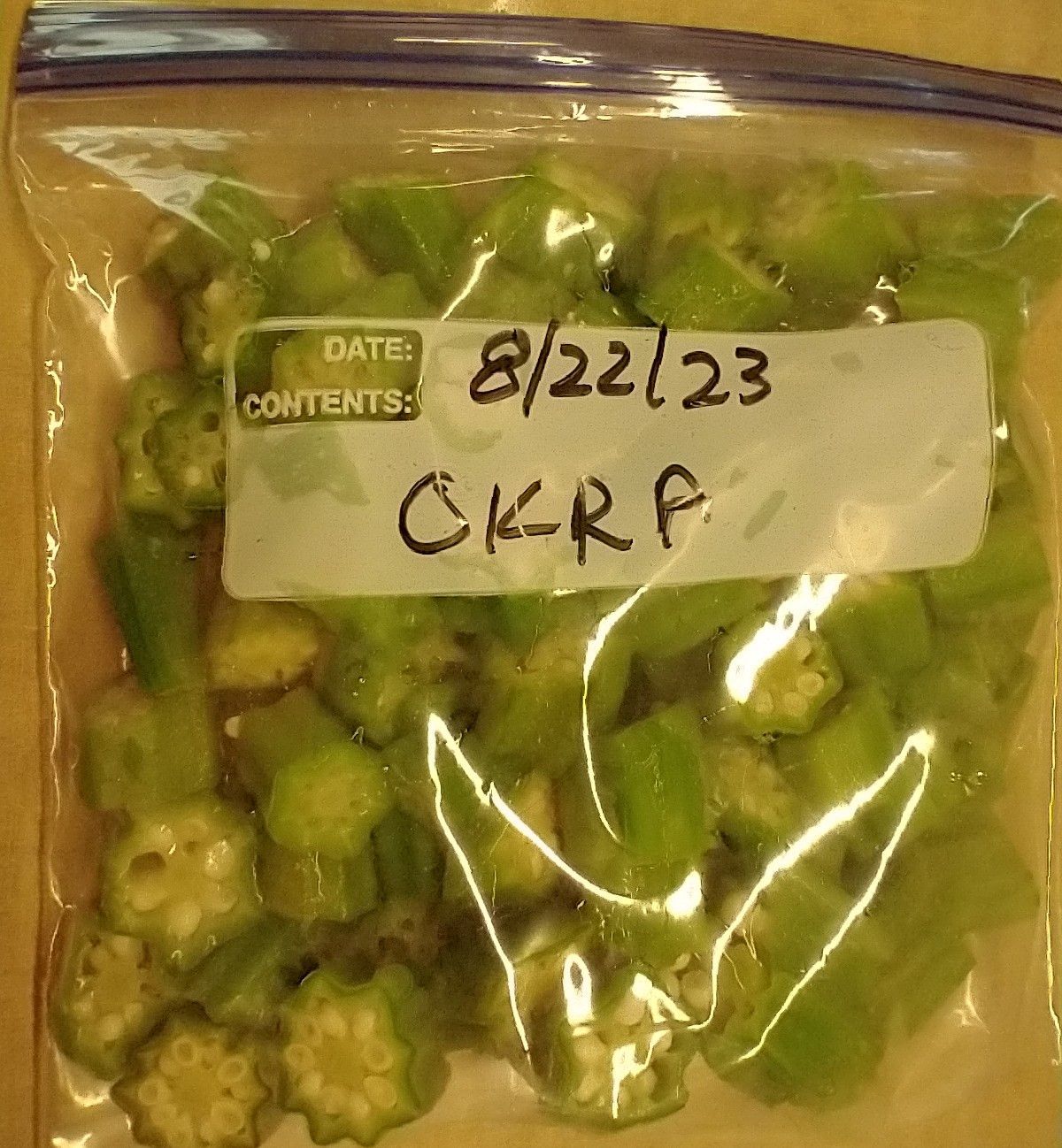 Quart bag of okra in labeled freezer bag