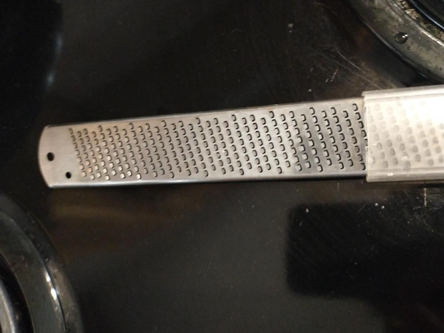 Photo of a zester used to shred ginger or turmeric rhizomes