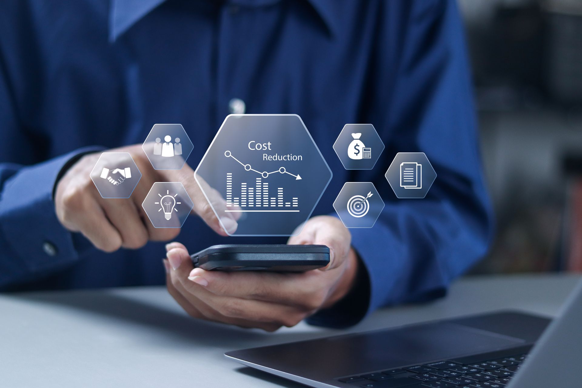 Person using a smartphone with holographic business and analytics icons floating above it