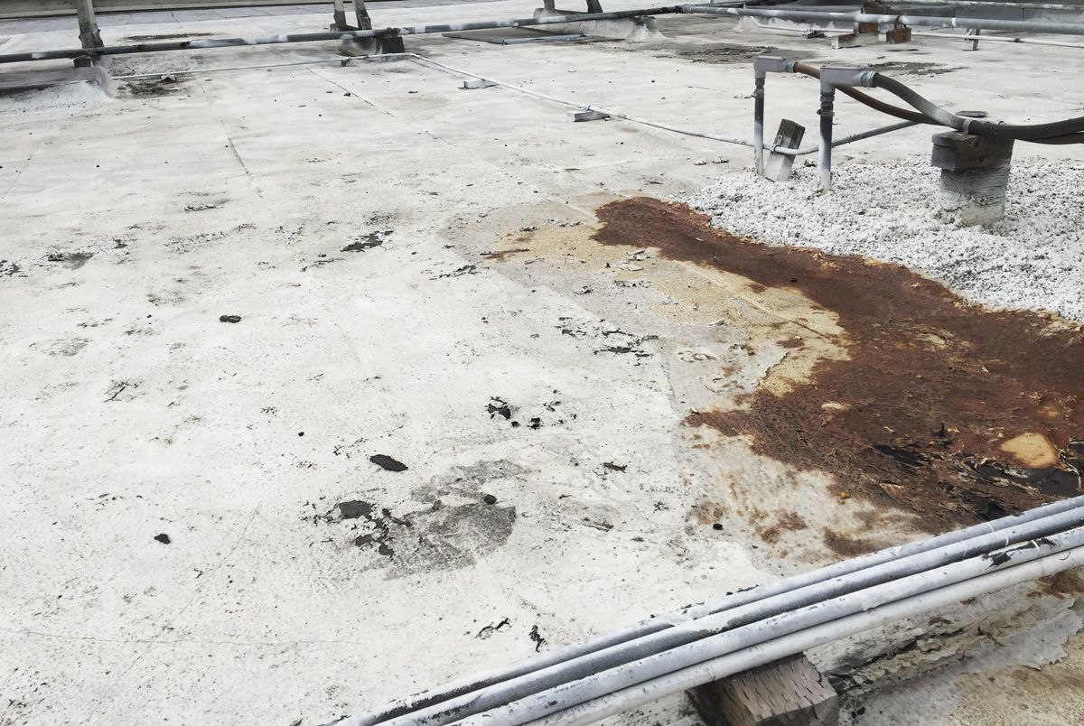 A dirty roof with a lot of rust on it