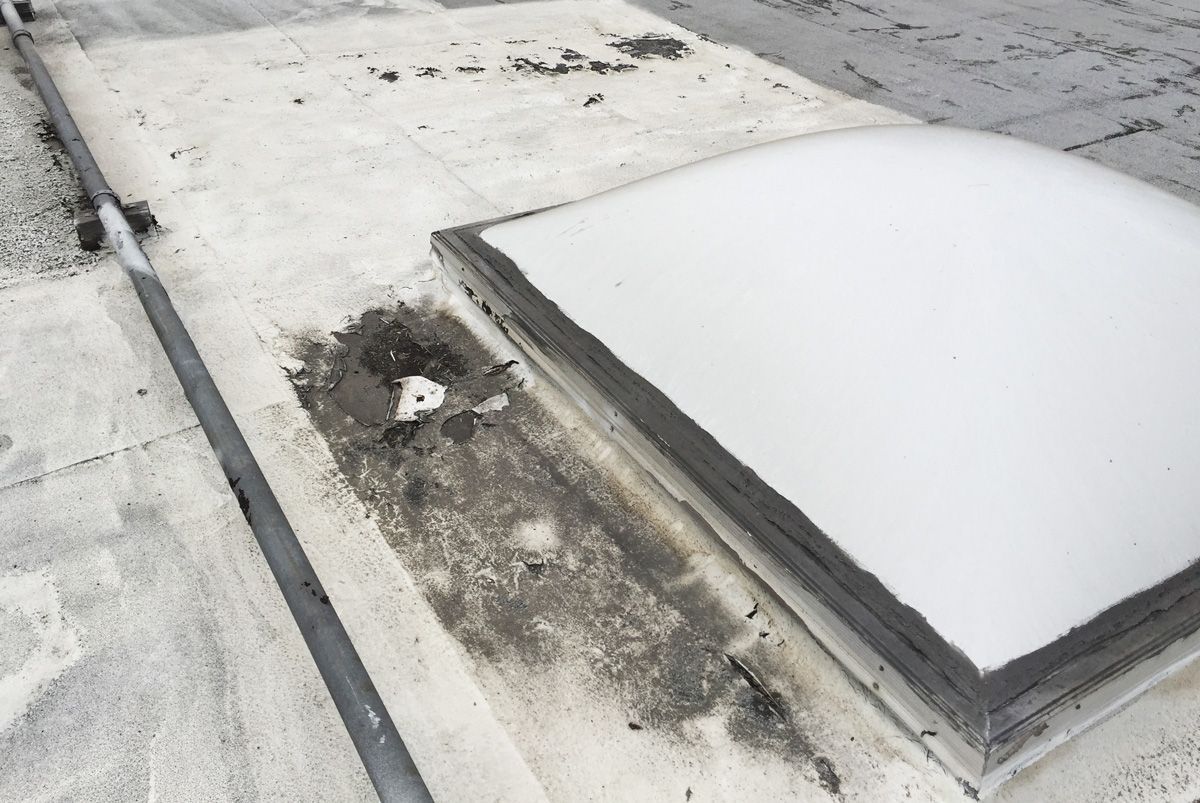 A skylight on a roof with a hole in it