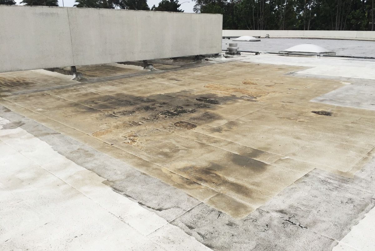 There is a lot of dirt on the roof of a building.