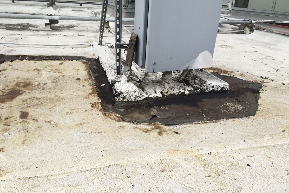 A dirty roof with a box on top of it