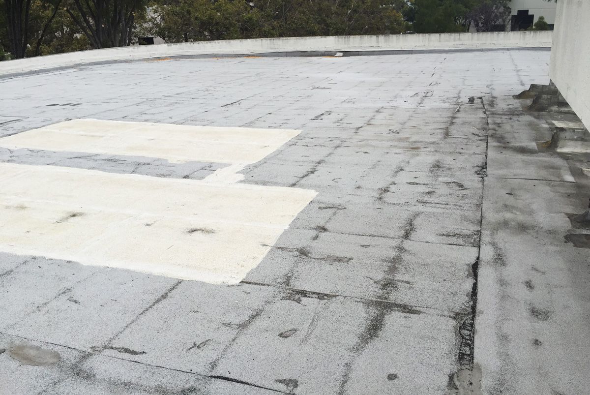 A roof with a white cross painted on it.