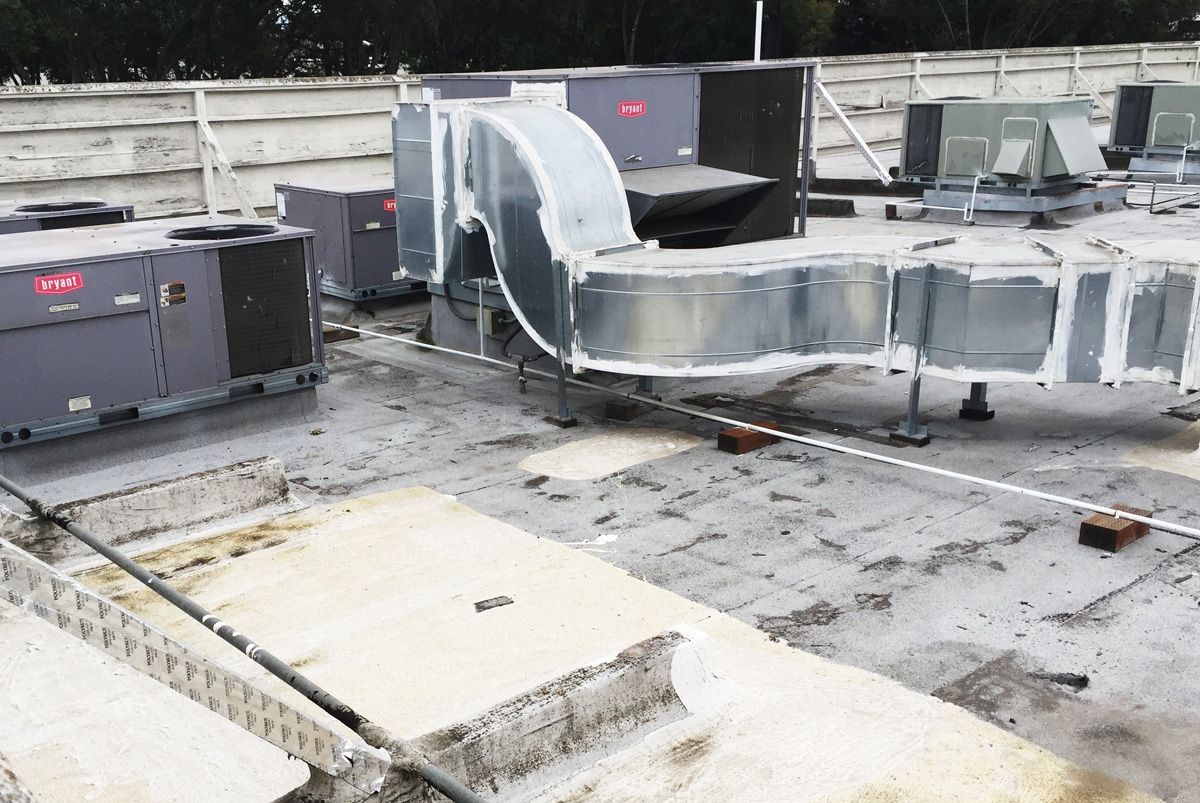 A rooftop with a lot of air conditioning equipment on it
