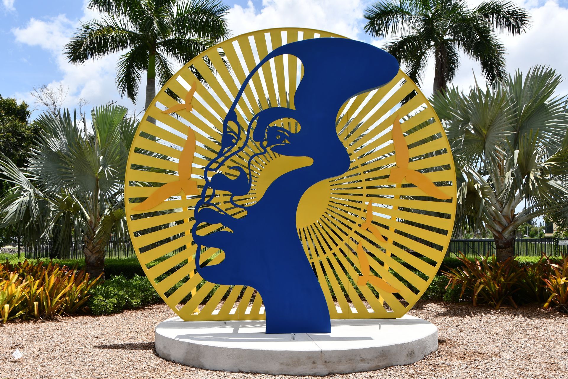 A blue and yellow sculpture of a face in a circle