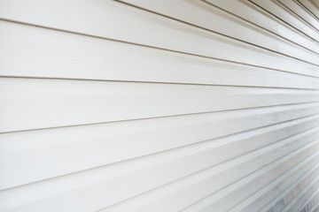 A close up of a white siding on a house.