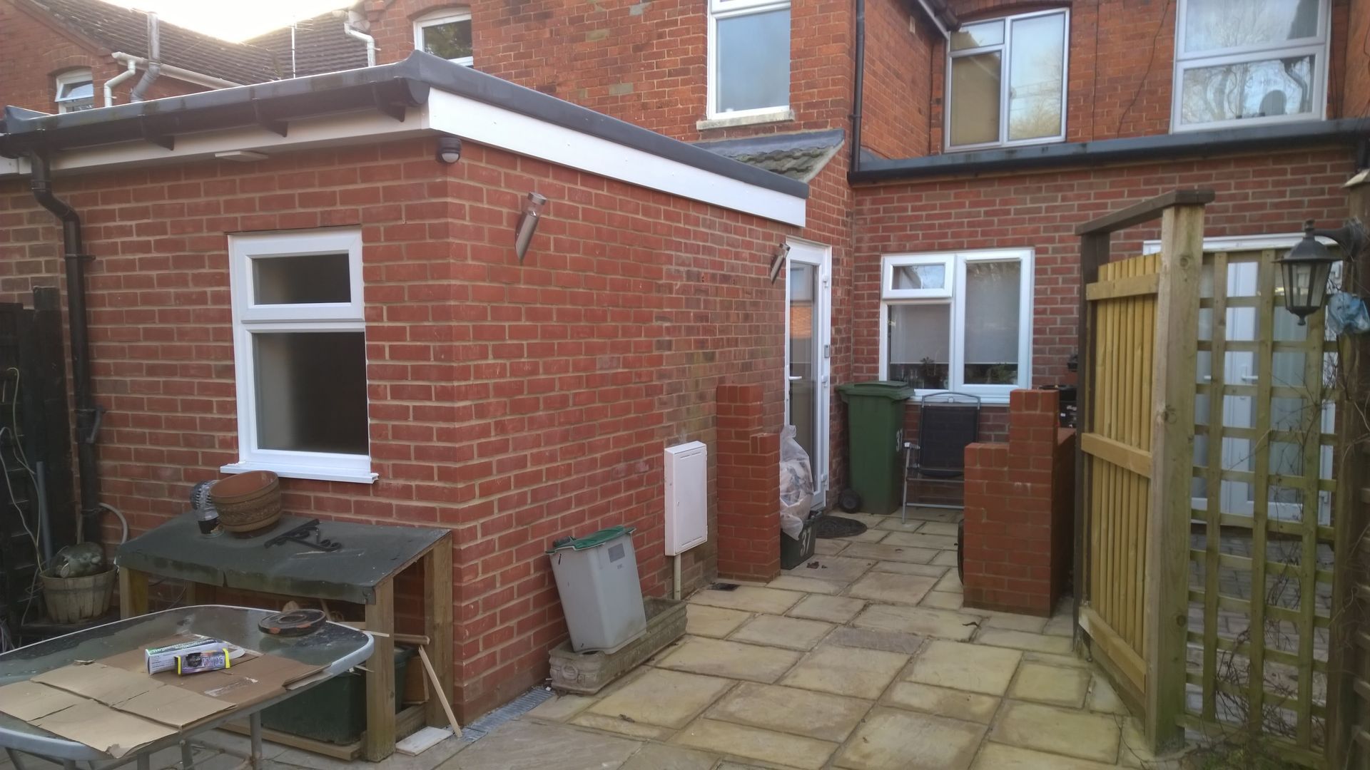 A brick building with a patio in front of it.