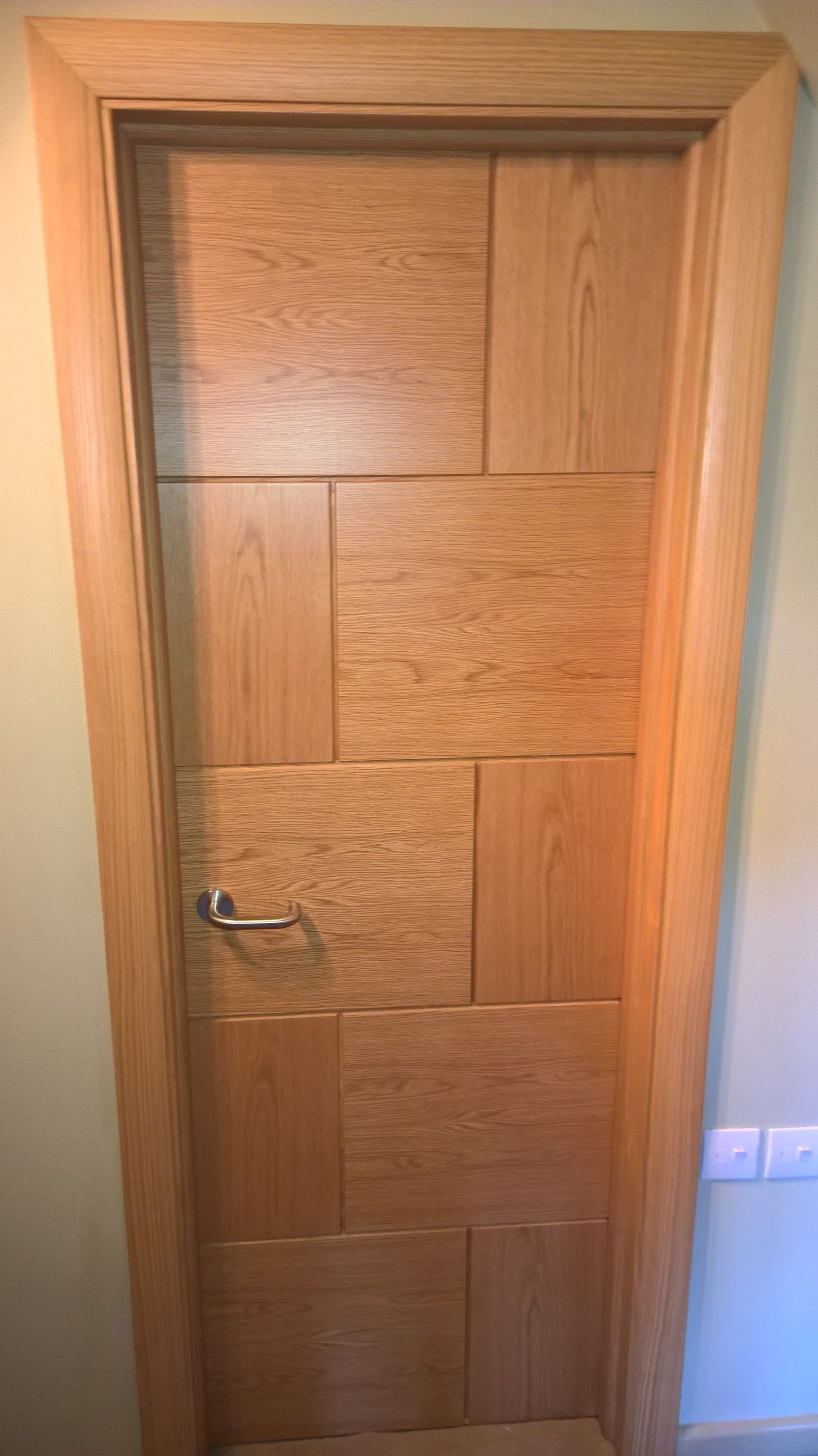 A close up of a wooden door in a room.