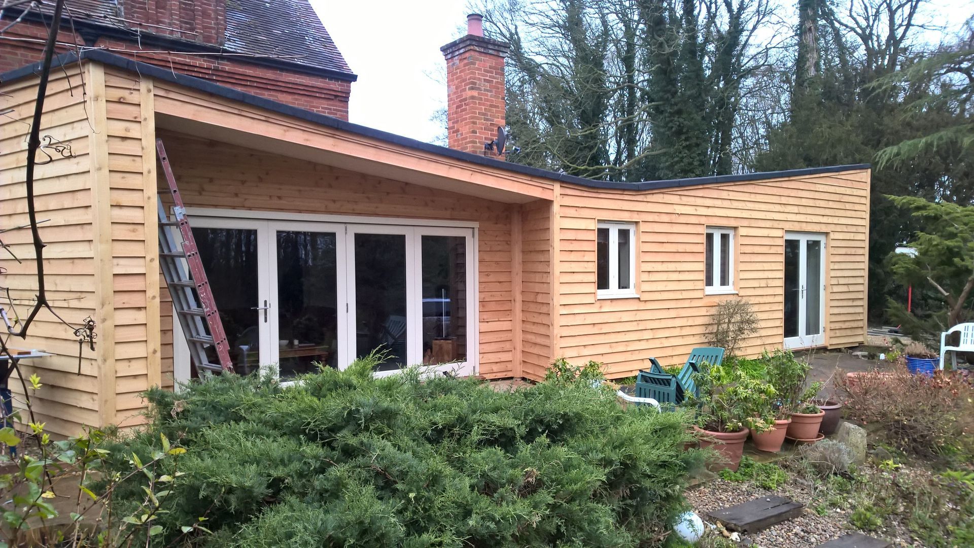 A wooden house with a ladder in front of it