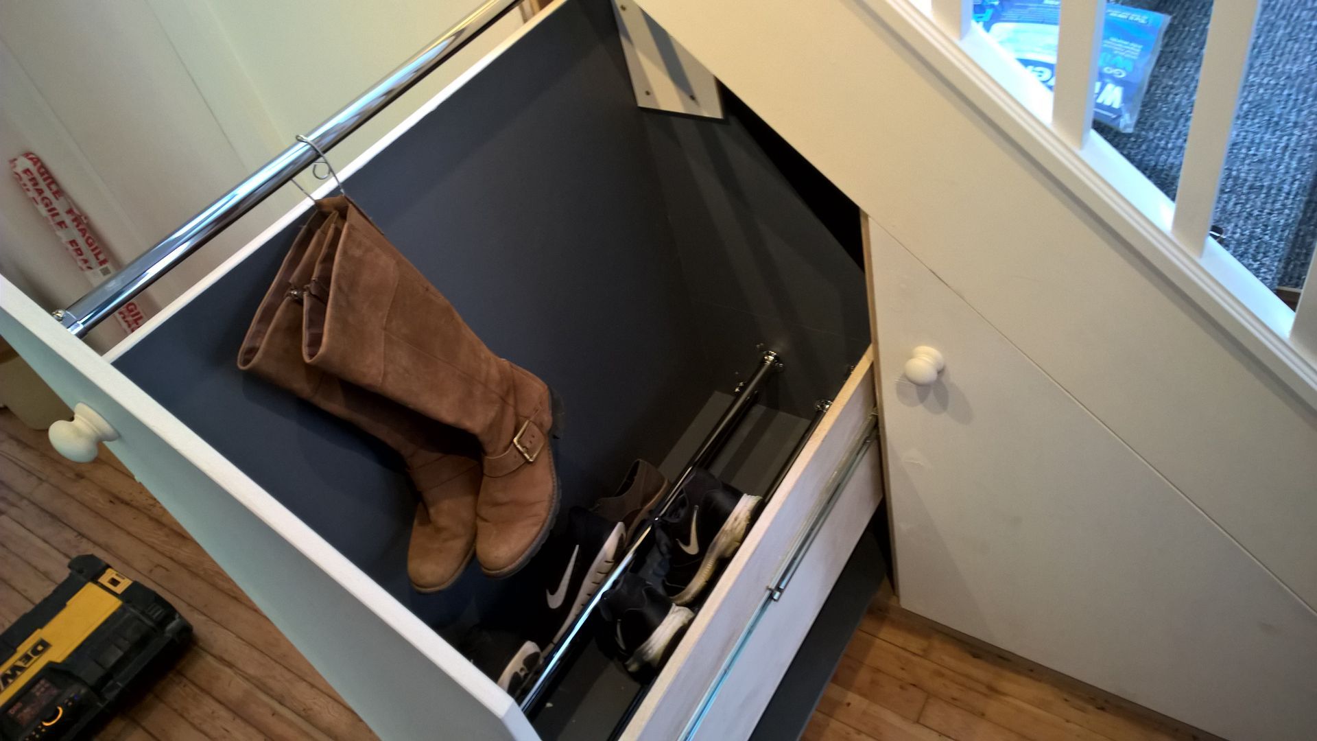 A drawer with a pair of boots in it