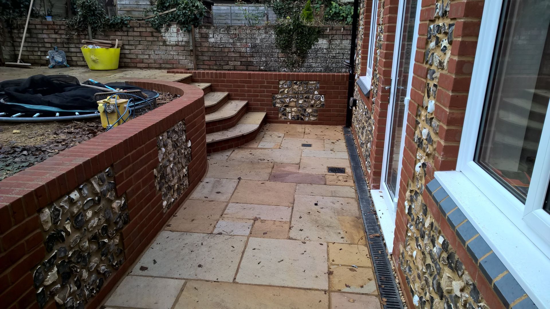 A brick building with a patio in front of it