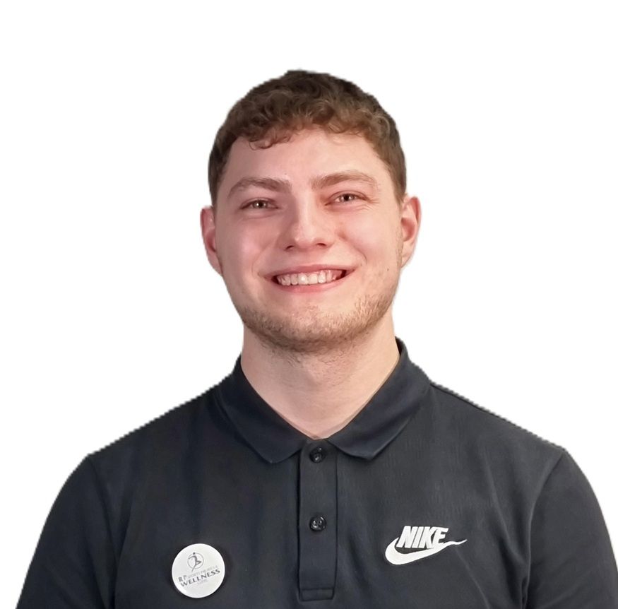 Daniel, a Sports Therapist at R P Sports Injuries and Wellness Clinic, smiles warmly while wearing a black Nike polo shirt.