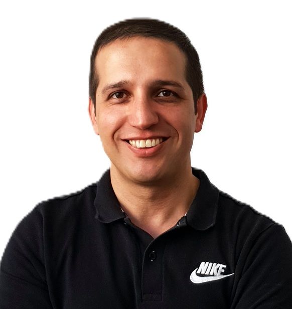 Mahdi, the founder and head Sports Therapist at R P Sports Injuries and Wellness Clinic, smiling confidently in a black shirt