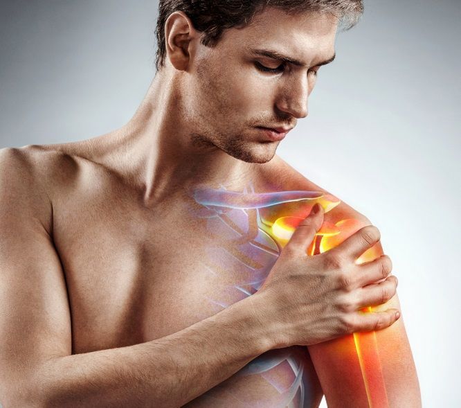 A man holding his painful shoulder