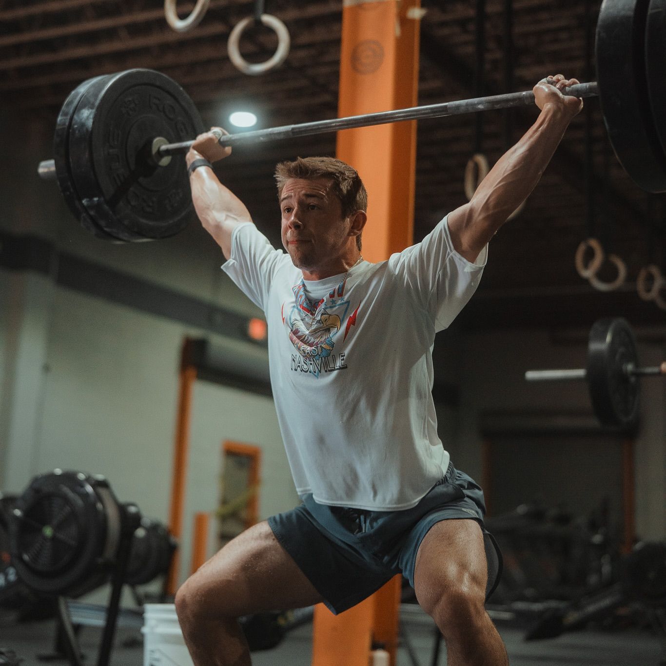 CrossFit athlete performing a barbell snatch in the gym