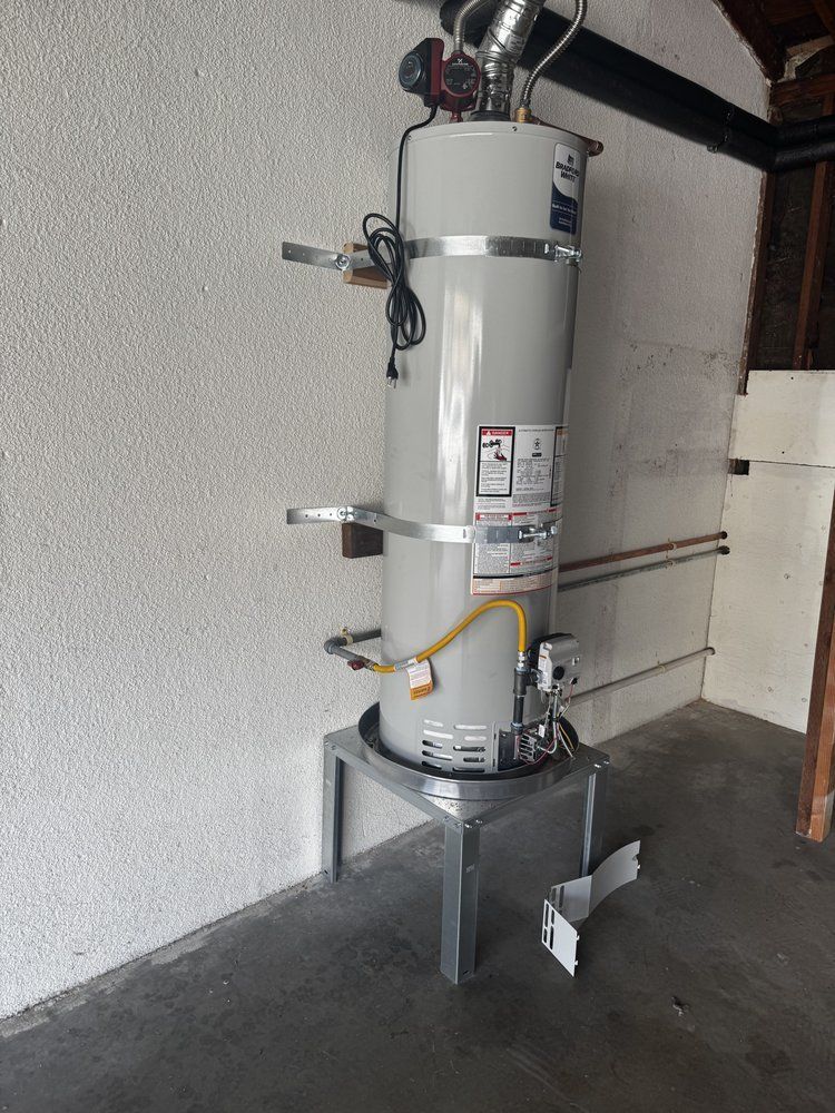 Wall-mounted water heater with pipes and a yellow gas line in a utility room