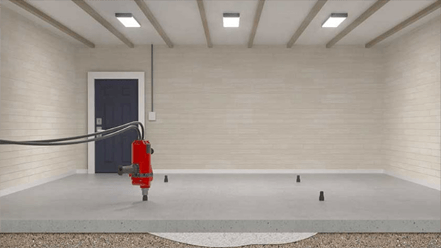 Indoor empty room with a red industrial robot arm on a gray floor near a wall and window.