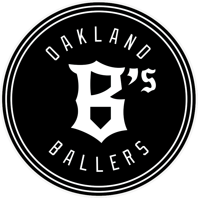 Black circular Oakland Ballers logo with white text and stylized “B’s” in the center