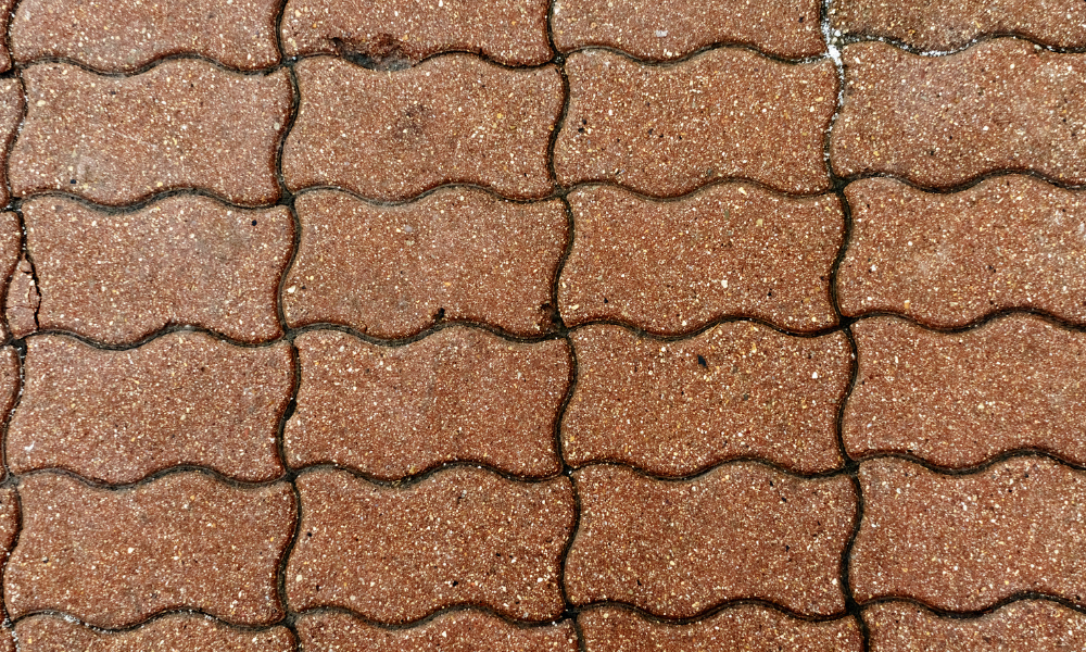 A close up of a brick walkway with a wave pattern.