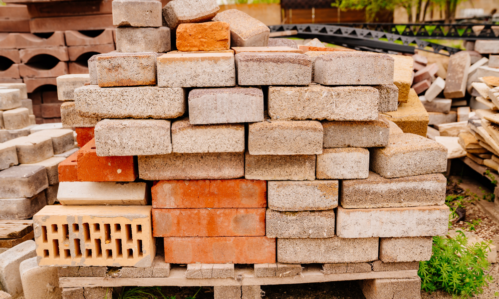 A pile of bricks stacked on top of each other on a wooden pallet.