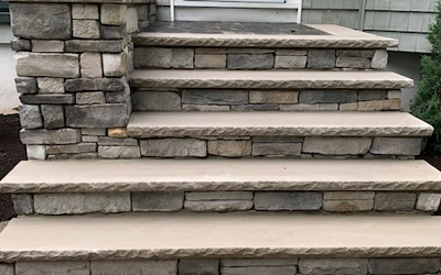 A set of stone stairs leading up to a house.