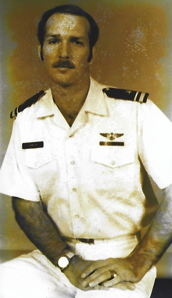 A man in a military uniform has a watch on his wrist
