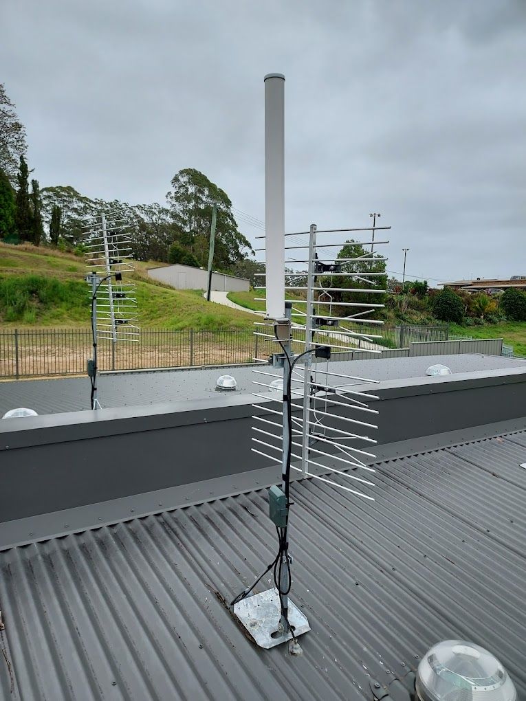 An Antenna is Sitting on Top of a Metal Roof — Coffs Coast Antenna Services in Coffs Harbour, NSW