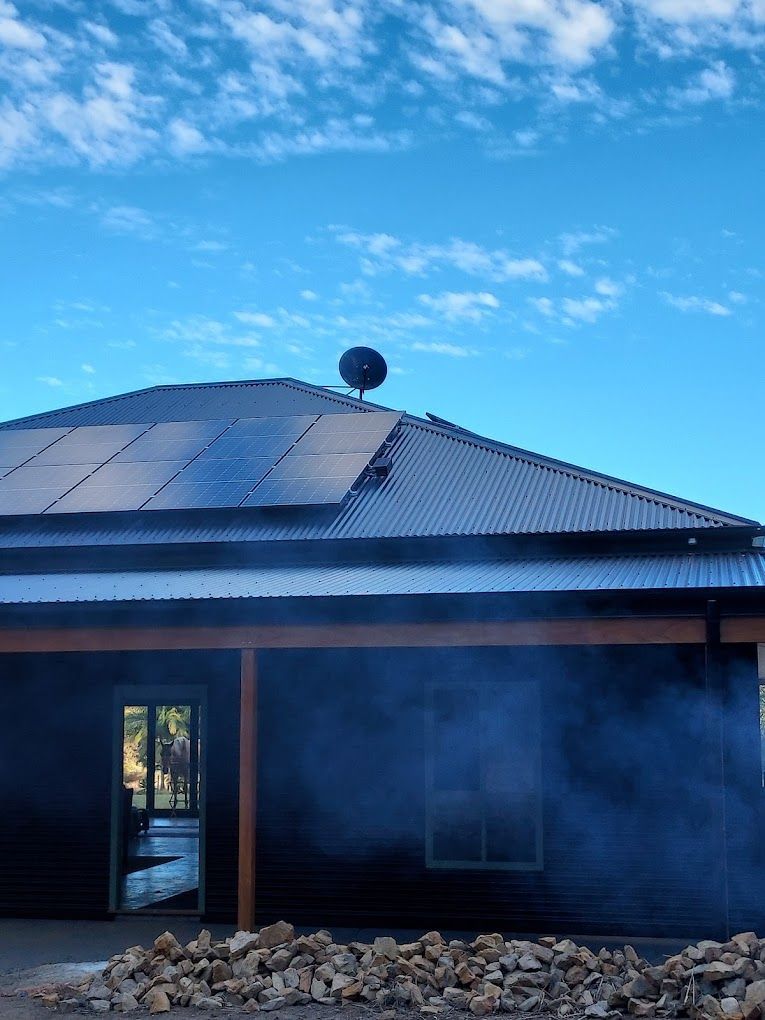 A House With Solar Panels on the Roof and a Tree on Top — Coffs Coast Antenna Services in Coffs Harbour, NSW