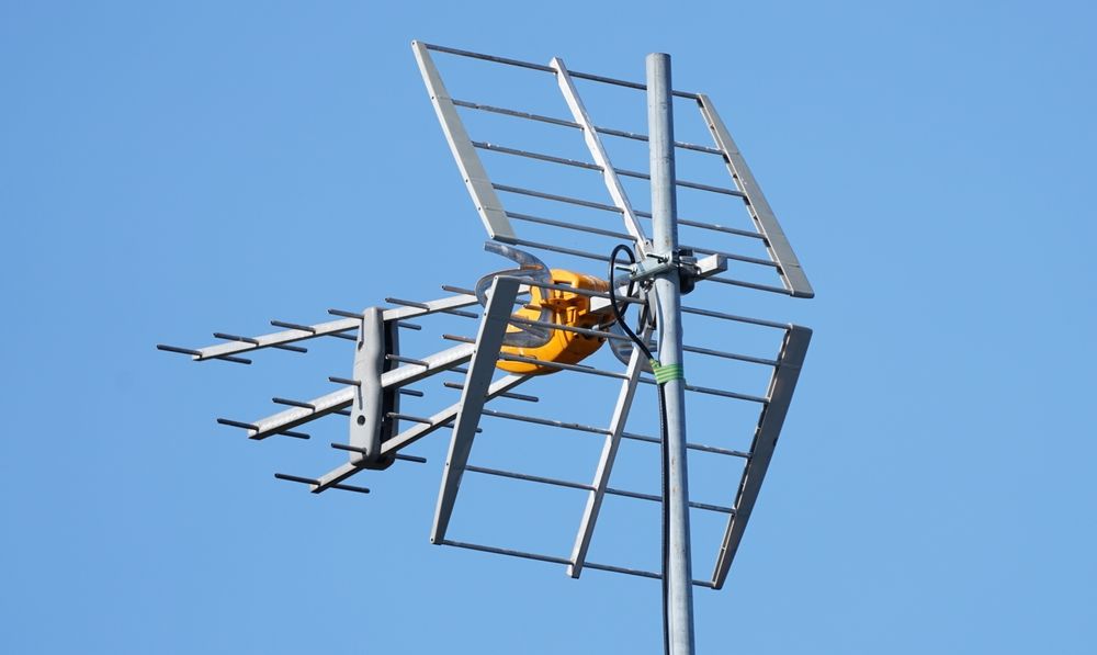 TV Antenna Behind a Blue Sky — Coffs Coast Antenna Services in Sawtell, NSW