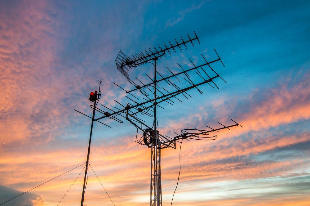 TV Antenna in Front Of Sunset — Coffs Coast Antenna Services in Eungai Creek, NSW
