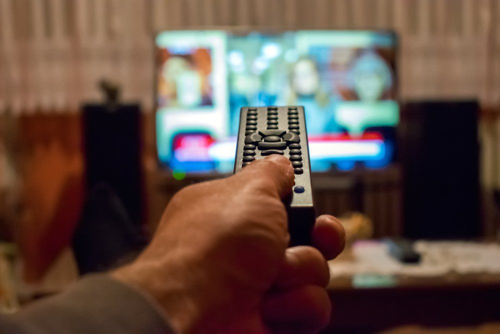 Changing TV Channel With Remote — Coffs Coast Antenna Services in Eungai Creek, NSW