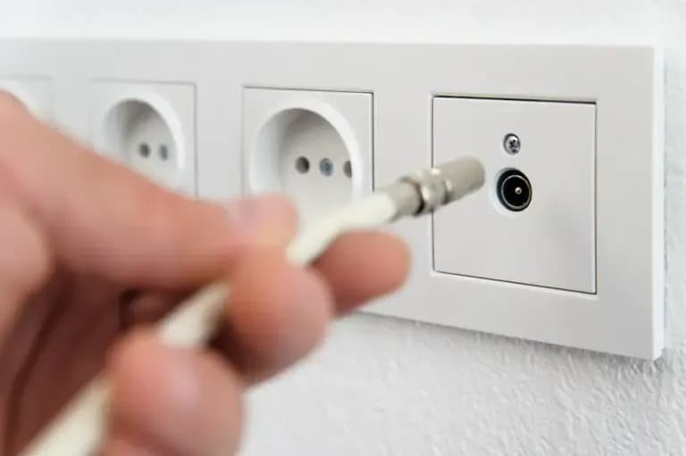 Plugging a TV Cable on an Outlet — Coffs Coast Antenna Services in Macksville, NSW
