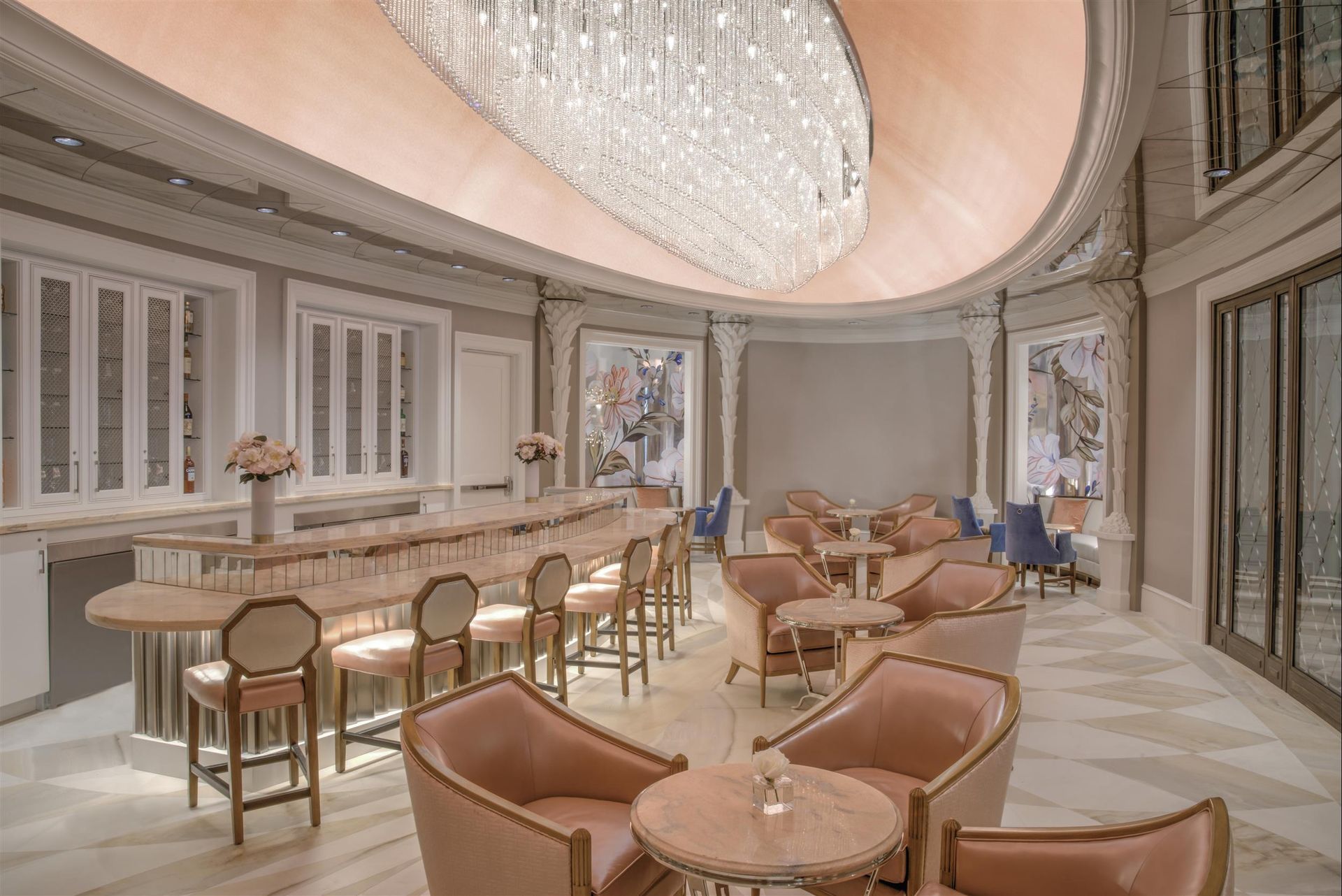 A large room with tables and chairs and a large chandelier.