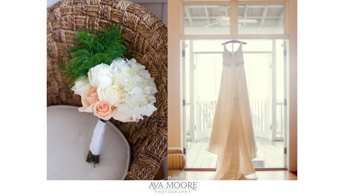 A bouquet of flowers and a wedding dress hanging on a hanger.