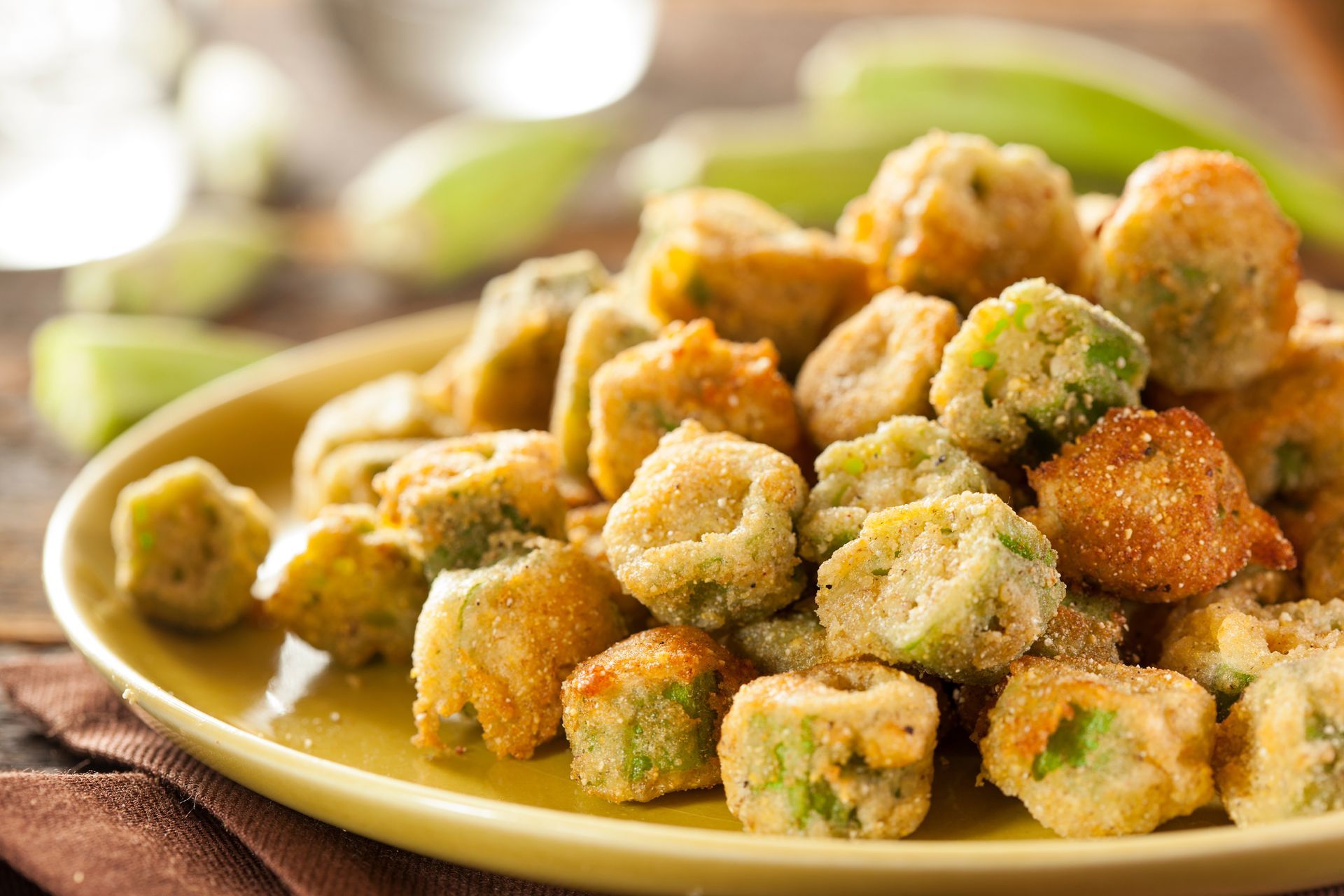 Fried okra on a yellow plate on a table.