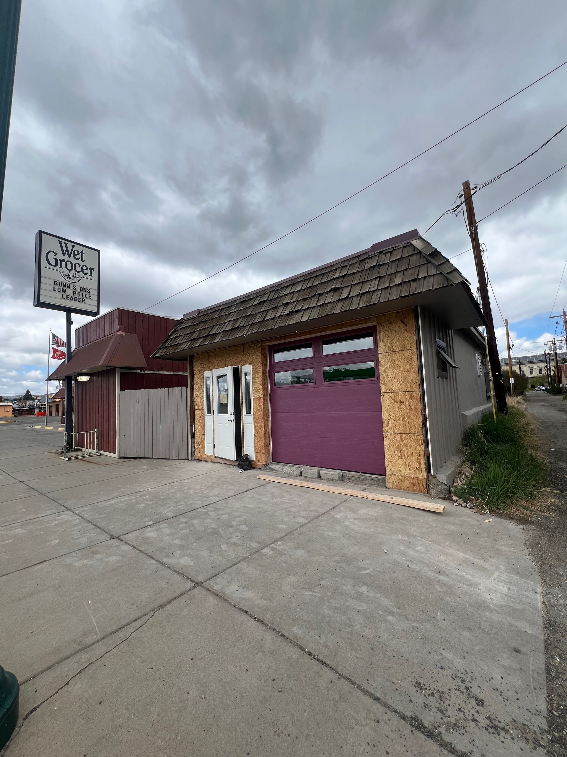 A small, run-down building with a sign for 